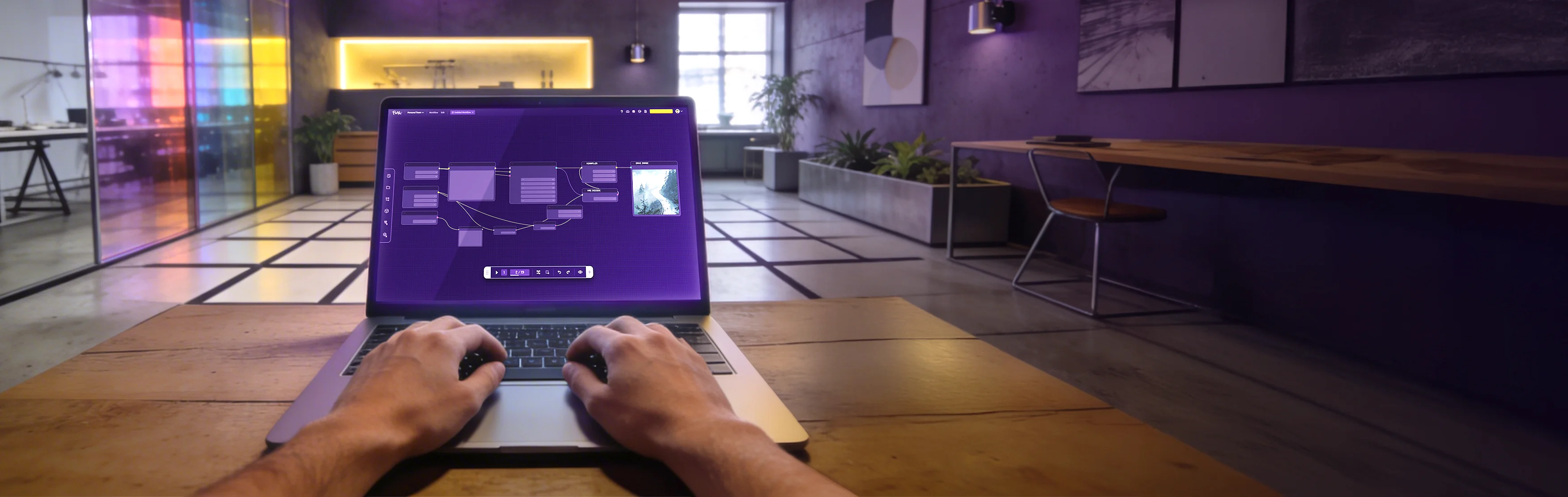 Hands on a laptop showing Floyo workflow editor in a studio environment