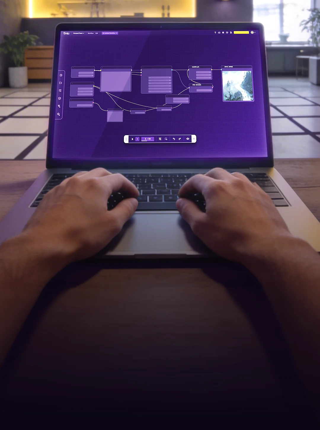 Hands on a laptop showing Floyo workflow editor in a studio environment